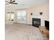 Comfortable living room with fireplace and large window, offering plenty of natural light at 2324 Bonterra Blvd, Indian Trail, NC 28079