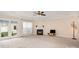 Bright living room featuring a fireplace, large window, and glass patio door at 2324 Bonterra Blvd, Indian Trail, NC 28079