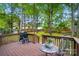 Back deck with a grill and a view of the treed backyard at 2426 Tory Oak Pl, Matthews, NC 28105