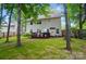 Backyard view of the home featuring a deck, lawn, and mature trees at 2426 Tory Oak Pl, Matthews, NC 28105
