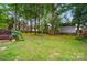 Backyard with a large treed yard and storage shed at 2426 Tory Oak Pl, Matthews, NC 28105