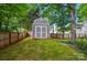 A backyard shed on a manicured lawn, offering practical storage space at 2426 Tory Oak Pl, Matthews, NC 28105