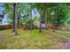 Backyard with a treed yard and storage shed at 2426 Tory Oak Pl, Matthews, NC 28105