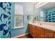 Bright and fun bathroom featuring a shark-themed shower curtain and natural wood vanity at 2426 Tory Oak Pl, Matthews, NC 28105