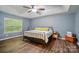 Spacious primary bedroom with trey ceilings, wood floors, and plenty of natural light at 2426 Tory Oak Pl, Matthews, NC 28105