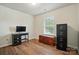 Spare room features hardwood floors, a window for light, and a built-in storage unit at 2426 Tory Oak Pl, Matthews, NC 28105