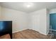 Small spare bedroom with wood floors, light gray walls, and a closet at 2426 Tory Oak Pl, Matthews, NC 28105