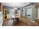 Hardwood floors, open layout, large windows, and neutral walls featured in the dining room space at 2426 Tory Oak Pl, Matthews, NC 28105