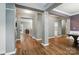 Open entryway with hardwood floors, elegant columns, and neutral paint, leading into the home at 2426 Tory Oak Pl, Matthews, NC 28105