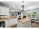 Bright kitchen overlooks the living and dining areas, featuring white cabinets and granite countertops at 2426 Tory Oak Pl, Matthews, NC 28105