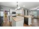 Well-lit kitchen features white cabinets, granite countertops, and stainless steel appliances at 2426 Tory Oak Pl, Matthews, NC 28105