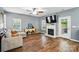 Cozy living room with a fireplace, hardwood floors, and comfortable seating at 2426 Tory Oak Pl, Matthews, NC 28105