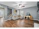 Comfortable living room features a gray sofa, ceiling fan, and wood-look flooring at 2426 Tory Oak Pl, Matthews, NC 28105
