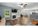Bright living room features a marble fireplace, windows, and wood-look flooring throughout at 2426 Tory Oak Pl, Matthews, NC 28105