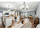 Open floor plan with kitchen, dining, and living areas provides ample natural light and wood-look floors at 2426 Tory Oak Pl, Matthews, NC 28105