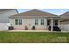 Back of home with a stone patio and well-maintained lawn offering a serene outdoor space at 274 Robinwood Ln, Lake Wylie, SC 29710