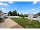 Large backyard featuring a well-maintained lawn, privacy fence, shed, and covered patio at 274 Robinwood Ln, Lake Wylie, SC 29710