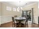 Cozy dining area with hardwood floors, traditional wainscotting, and sliding glass doors to the outdoor living space at 274 Robinwood Ln, Lake Wylie, SC 29710