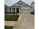 Charming single-Gathering home with a well-maintained lawn, inviting curb appeal, and an attached two car garage at 274 Robinwood Ln, Lake Wylie, SC 29710