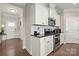 Modern kitchen featuring white cabinets, stainless steel appliances, granite countertops, and hardwood flooring at 274 Robinwood Ln, Lake Wylie, SC 29710