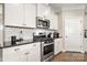 A lovely kitchen features stainless steel appliances, white cabinets, granite countertops, and subway tile backsplash at 274 Robinwood Ln, Lake Wylie, SC 29710