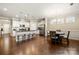 Open concept kitchen with a breakfast bar, white cabinets, granite countertops and stainless appliances at 274 Robinwood Ln, Lake Wylie, SC 29710