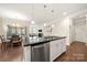 The kitchen has stainless steel appliances, granite countertops and an island that opens to the living area at 274 Robinwood Ln, Lake Wylie, SC 29710