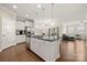 Open concept kitchen with white cabinets, island with sink, stainless appliances, and hardwood floors at 274 Robinwood Ln, Lake Wylie, SC 29710