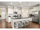 Modern kitchen with stainless steel appliances, granite counters, white cabinets, island, and breakfast bar seating at 274 Robinwood Ln, Lake Wylie, SC 29710