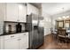 Updated kitchen with stainless steel refrigerator, granite countertops, and white cabinetry at 274 Robinwood Ln, Lake Wylie, SC 29710