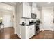 Bright kitchen featuring stainless steel appliances, white cabinets, granite counters, and hardwood floors at 274 Robinwood Ln, Lake Wylie, SC 29710