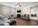Bright living room with hardwood floors, ceiling fan, fireplace, and neutral paint that creates a warm and inviting atmosphere at 274 Robinwood Ln, Lake Wylie, SC 29710