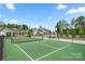 Community tennis court ready for a match, set among lush green trees and landscaping at 274 Robinwood Ln, Lake Wylie, SC 29710