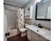 Bright and renovated bathroom with shiplap wall, modern fixtures, vanity, and tub/shower combo at 2800 Patio Ln, Gastonia, NC 28056