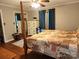 Bright bedroom with wood floors, patterned quilt, closet, dresser, and natural light at 2800 Patio Ln, Gastonia, NC 28056