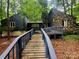 Stunning exterior showcasing a home with a stone facade and a charming wooden walkway at 2800 Patio Ln, Gastonia, NC 28056