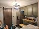 Well-lit kitchen with stainless steel refrigerator, wooden cabinets, stylish light fixture, and a rustic barn door at 2800 Patio Ln, Gastonia, NC 28056