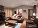 Bright living room with a stone fireplace, hardwood floors, and comfortable leather furniture at 2800 Patio Ln, Gastonia, NC 28056