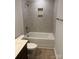 Bathroom with a tub, shower and vanity featuring modern fixtures and grey tile at 2910 Sloan Dr, Charlotte, NC 28208