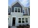 Charming townhome with gray and light gray siding, white trim, and well-manicured landscaping at 2910 Sloan Dr, Charlotte, NC 28208