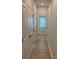 Hallway with hardwood floors and multiple closets, leading to a bathroom with natural light at 2910 Sloan Dr, Charlotte, NC 28208