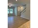 Open-concept living area with hardwood floors, staircase, and lots of natural light at 2910 Sloan Dr, Charlotte, NC 28208