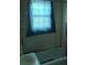 A bathroom featuring a shower-tub, and a window partially covered by a curtain at 2925 Titman Rd, Gastonia, NC 28054
