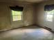 A bedroom with windows and dated curtains needs some love at 2925 Titman Rd, Gastonia, NC 28054