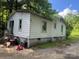 Rear exterior view of a one-story home needing some repairs and maintenance at 2925 Titman Rd, Gastonia, NC 28054