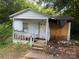 A weathered exterior elevation shows damage on a one-story home with a small porch at 2925 Titman Rd, Gastonia, NC 28054