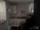 A simple kitchen with white cabinets and basic appliances needs work at 2925 Titman Rd, Gastonia, NC 28054