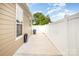 Back patio with white fence and tan exterior at 309 N Aspen St, Lincolnton, NC 28092