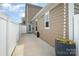Back patio with white fence, tan exterior and greenery at 309 N Aspen St, Lincolnton, NC 28092