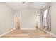 Bright bedroom with neutral carpet and paint, featuring high vaulted ceiling and natural light from the window at 309 N Aspen St, Lincolnton, NC 28092